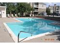 Community pool with lounge chairs and clear water, perfect for relaxing at 4896 S Dudley St # 8, Littleton, CO 80123