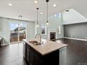 Open kitchen design with dark wood cabinets, granite countertops, and stainless steel appliances at 10730 Hillrose St, Parker, CO 80134