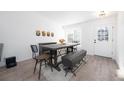 Bright dining room with wood table, seating for six, modern light fixture, and light wood flooring at 4485 E Andover Ave, Castle Rock, CO 80104