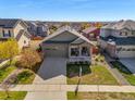 Single Gathering home with a well-manicured lawn, attached two-car garage, and welcoming front porch at 6267 N Dunkirk Ct, Aurora, CO 80019