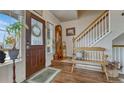 Inviting entryway featuring hardwood floors, a bench, and a staircase at 16184 Gold Creek Dr, Monument, CO 80132