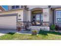 Inviting front porch with decorative details and a charming entrance to the home, with stone accents at 16184 Gold Creek Dr, Monument, CO 80132