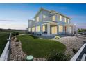 Spacious backyard with lush green grass, white fence, and a cozy patio for outdoor enjoyment at 1842 Peak Prairie Ln, Monument, CO 80132