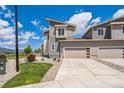 Well-maintained home with a garage, complemented by green grass, and landscaping at 1842 Peak Prairie Ln, Monument, CO 80132