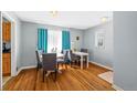 Cozy dining room featuring hardwood floors, a modern table, and bright, natural lighting at 3492 S Elm St, Denver, CO 80222
