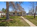 Charming single-story home featuring a well-maintained lawn and mature trees in a suburban setting at 3492 S Elm St, Denver, CO 80222