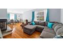 Bright living room with hardwood floors, large sectional sofa, and ample natural light at 3492 S Elm St, Denver, CO 80222