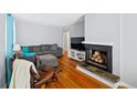 Inviting living room with hardwood floors, a cozy fireplace, and comfortable seating arrangements at 3492 S Elm St, Denver, CO 80222
