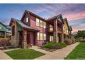 Attractive exterior featuring colorful siding, stone pillars, covered entryway, and well-maintained lawn at 2552 W 82Nd Ln # C, Westminster, CO 80031