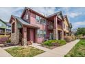 Two-story home featuring a porch with stone columns and green lawn at 2552 W 82Nd Ln # C, Westminster, CO 80031