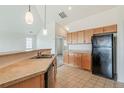 Bright kitchen featuring stainless steel sink and black appliances at 2552 W 82Nd Ln # C, Westminster, CO 80031