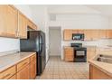 Bright kitchen features wood cabinets, black appliances, and tiled floors at 2552 W 82Nd Ln # C, Westminster, CO 80031