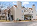 Exterior view of a multi-story condo building with tidy landscaping, stairs leading to second-floor units, and ample parking at 2658 S Xanadu Way # B, Aurora, CO 80014