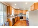 Well-lit kitchen featuring stainless steel appliances, wood cabinets and countertops, and backsplash at 535 Lost Valley Pt, Castle Rock, CO 80108