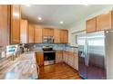 Well-lit kitchen featuring stainless steel appliances, wood cabinets and countertops, and backsplash at 535 Lost Valley Pt, Castle Rock, CO 80108
