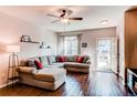Living room with hardwood floors, natural light, and a sectional couch at 535 Lost Valley Pt, Castle Rock, CO 80108