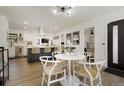 Open-concept dining area featuring a round table and access to the kitchen, creating a cohesive living space at 4895 E Arizona Ave, Denver, CO 80246