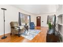 Bright living room with hardwood floors, large windows, and comfortable seating arrangement at 2434 S Ogden St # 2434-2436, Denver, CO 80210