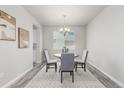 Cozy dining room with a round table, chandelier, and neutral color scheme at 12941 Delaware St, Westminster, CO 80234