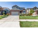 Inviting two-story home boasting a brick facade, attached garage, and manicured lawn at 12941 Delaware St, Westminster, CO 80234