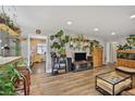 Open living area showcasing hardwood floors, large plant shelves, and seamless flow at 1801 S Eudora St, Denver, CO 80222