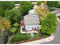 Aerial view of the backyard featuring a well-kept lawn, a deck with outdoor seating, and mature trees at 10911 Tennyson Ct, Westminster, CO 80031