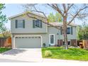 Charming two-story home featuring a well-manicured lawn, mature tree, and an attached two-car garage at 10911 Tennyson Ct, Westminster, CO 80031