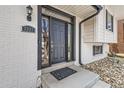 Close-up of the elegant front door with stylish hardware and a welcoming entrance at 2221 S Arbutus Ct, Lakewood, CO 80228