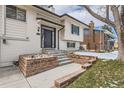 Beautiful front entrance with brick accents and a well-maintained walkway leading to the front door at 2221 S Arbutus Ct, Lakewood, CO 80228