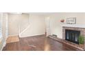 Living room with fireplace, hardwood floors, and stairs at 2427 E Fremont Ct, Centennial, CO 80122