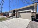 Beautiful single-Gathering home featuring stone accents and an attached two-car garage at 9477 Market Ln, Parker, CO 80134