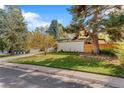 A lovely home with a well-kept lawn and mature trees at 1392 S Edison Way, Denver, CO 80222