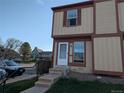 Charming townhouse featuring a two-story design with a neat front yard, steps leading to a welcoming entrance at 14465 E Hawaii Cir # A, Aurora, CO 80012