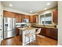 Modern kitchen features stainless steel appliances, granite countertops, and a breakfast bar at 1100 Rockhurst Dr # A, Highlands Ranch, CO 80129