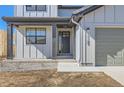 Inviting front entrance with modern design, stylish door, and well-manicured landscaping at 3109 Newfound Lake Rd, Berthoud, CO 80513