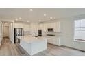Spacious kitchen with an island, stainless steel appliances, and plenty of white cabinets at 661 Sunrise St, Erie, CO 80516