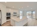 Bright, modern kitchen features a large island, stainless steel appliances, and ample cabinet space at 661 Sunrise St, Erie, CO 80516