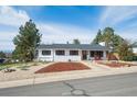 Attractive single-story home featuring a well-maintained lawn and inviting front porch at 391 Burgess Dr, Castle Rock, CO 80104