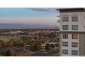 Modern building exterior with city skyline and mountain views in the background at 5455 Landmark Pl # 1106, Greenwood Village, CO 80111