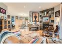 Open living room with wood floors, fireplace, stylish decor, and a seamless flow to the dining area at 1753 Race St, Denver, CO 80206