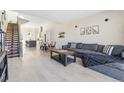 Bright, open living space featuring a modern staircase and a spacious seating area connected to the kitchen and dining area at 5125 W 29Th Ave # 5, Denver, CO 80212