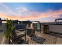 Cozy rooftop deck with fire pit, stylish seating, and beautiful sunset views at 5125 W 29Th Ave # 5, Denver, CO 80212
