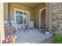 Welcoming front porch featuring comfortable seating, perfect for relaxing and enjoying the outdoors at 10550 Ashfield St, Highlands Ranch, CO 80126