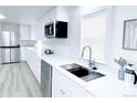 Bright kitchen with stainless steel appliances, white cabinets and sink at 815 Plum Ave, Lochbuie, CO 80603