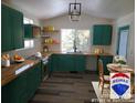 Eat-in kitchen with natural wood countertops, green cabinets, and stainless steel appliances at 11967 W Ranch Elsie Rd, Golden, CO 80403