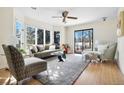 Sun-drenched living room featuring a plush sofa, elegant chairs, and large windows overlooking the backyard at 6843 Fairview Dr, Boulder, CO 80303