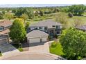Beautiful two-story home with a three-car garage, landscaped yard, and manicured lawn at 8806 Tuscany Ln, Highlands Ranch, CO 80130