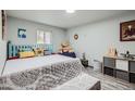 Cozy bedroom featuring a unique headboard, comfortable bed, and ample natural light from the window at 3081 W 18Th Ave, Denver, CO 80204