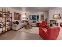 Cozy living room with stylish decor, comfortable seating, and ample natural light from a large window at 20520 E Regency Way, Parker, CO 80138