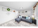 Cozy living room featuring a comfortable sectional sofa and decorative accents at 1502 Carmelita Ct, Platteville, CO 80651